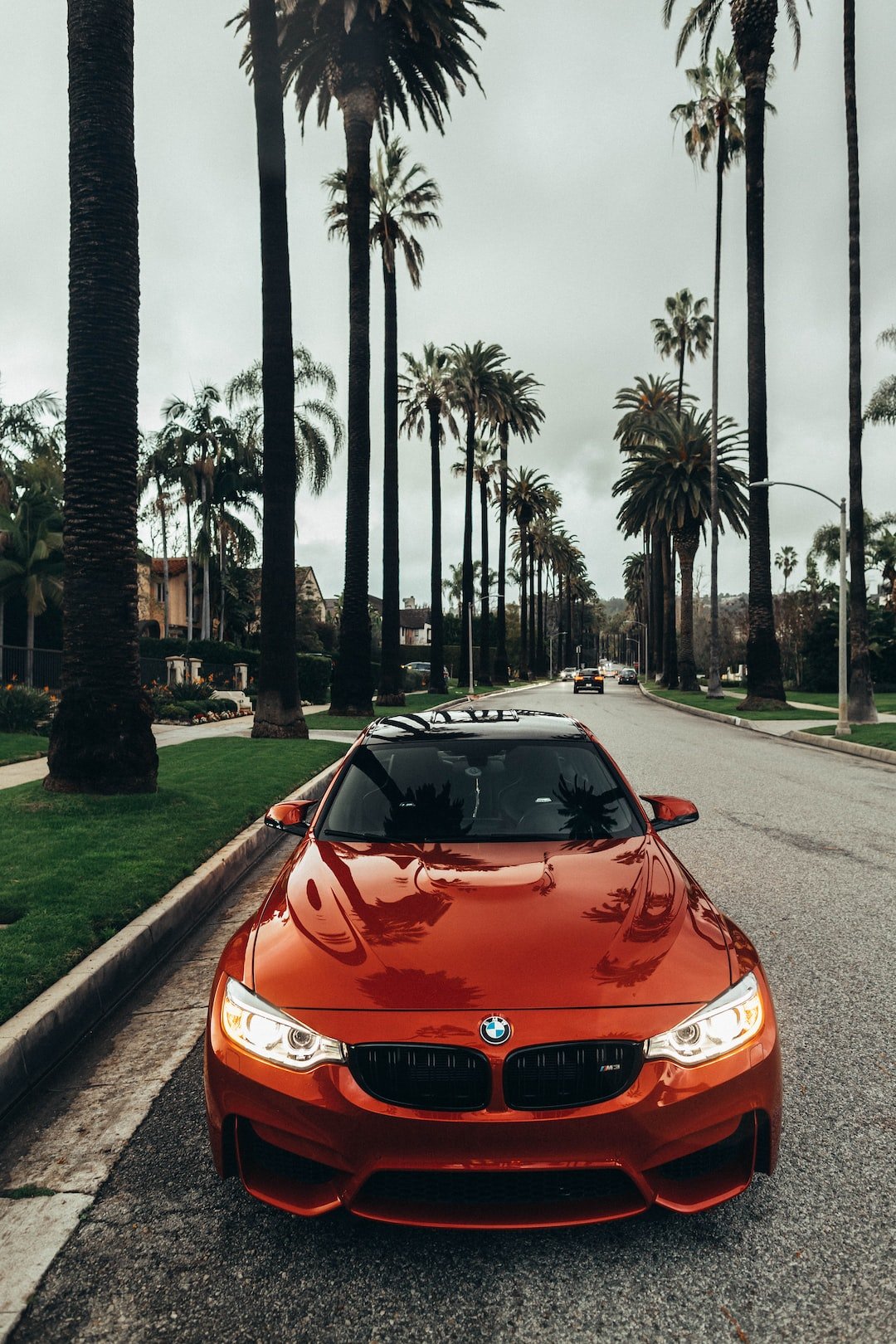 red BMW coupe parked at road